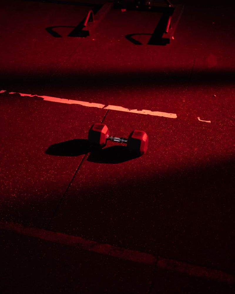 Athletic equipment on a dark gym floor with dramatic lighting